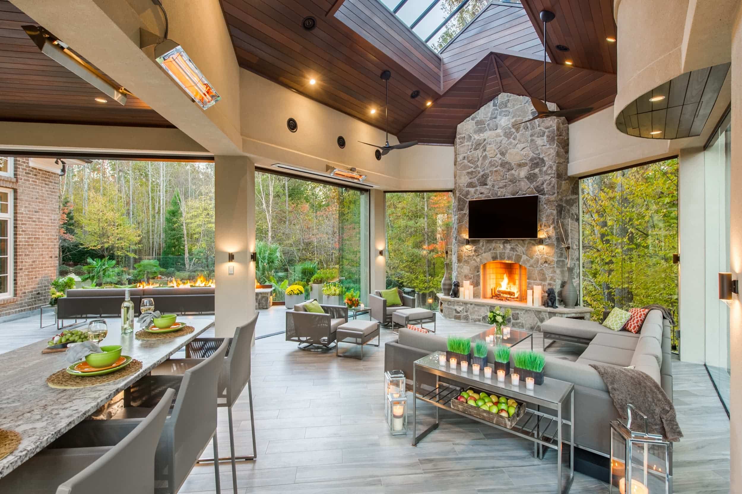 A large living room with a fireplace and large windows.