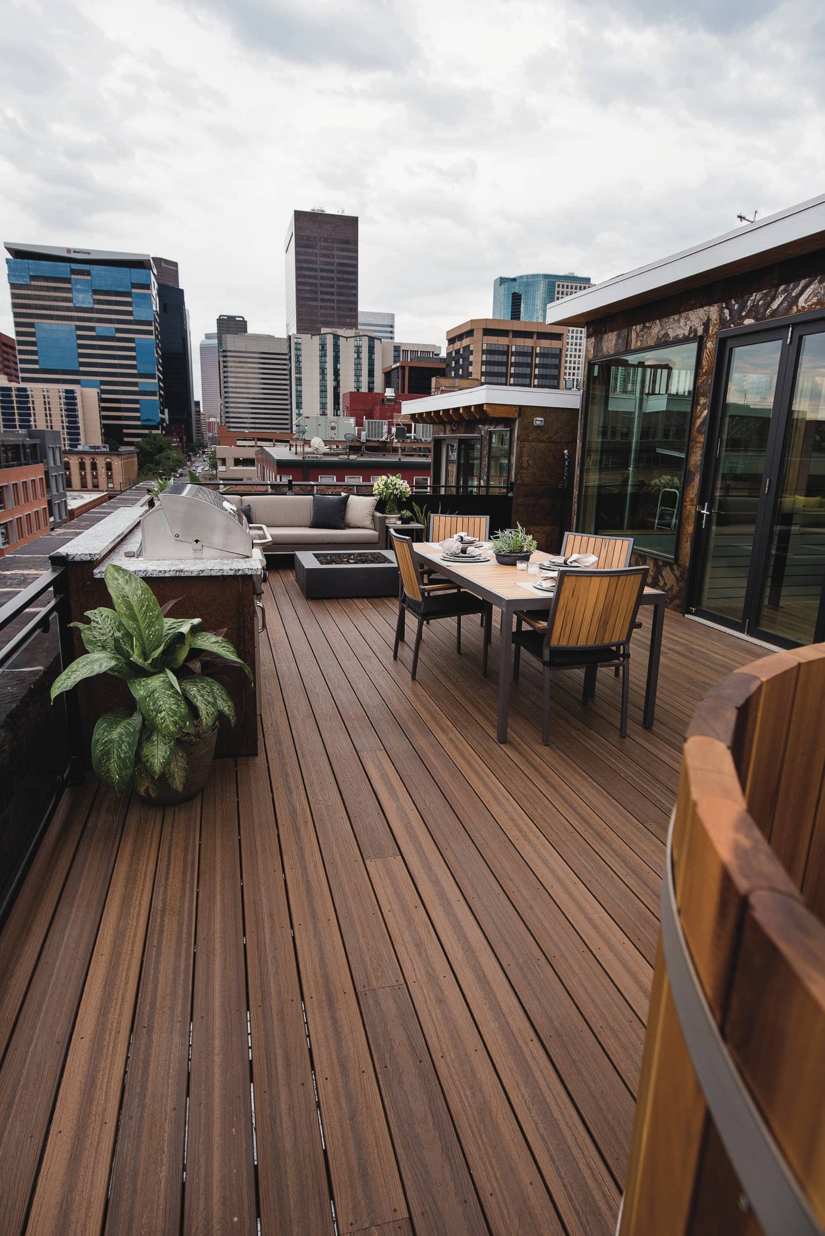A rooftop deck with a table and chairs.