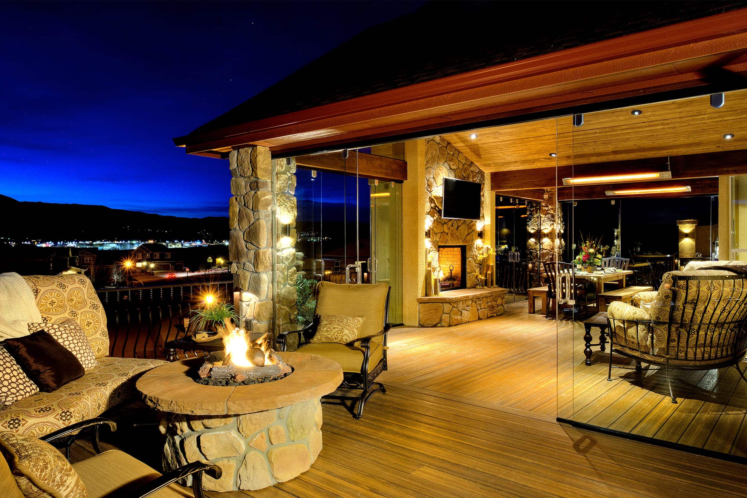 A wooden deck with a fire pit.