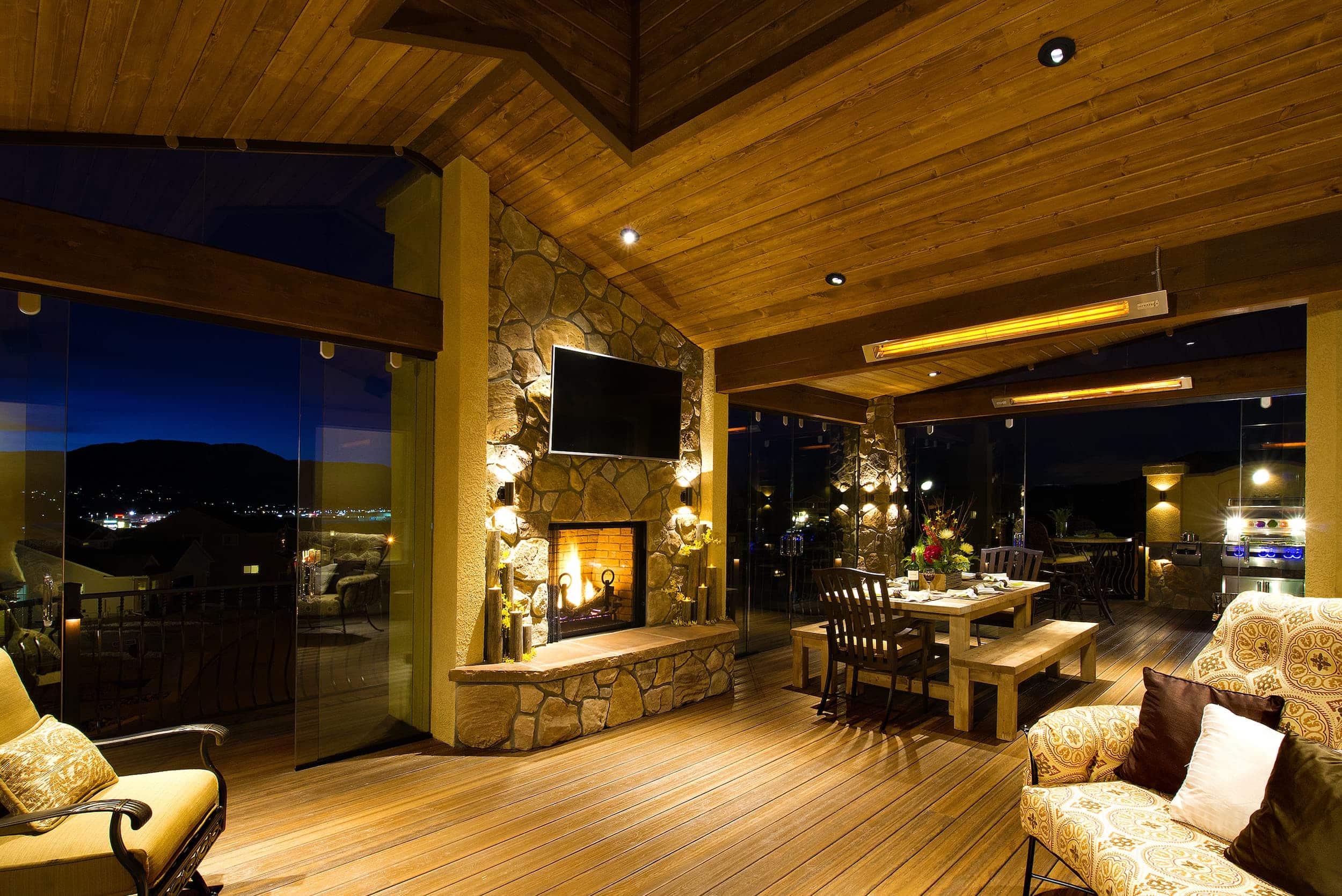 A wooden deck with a fireplace.
