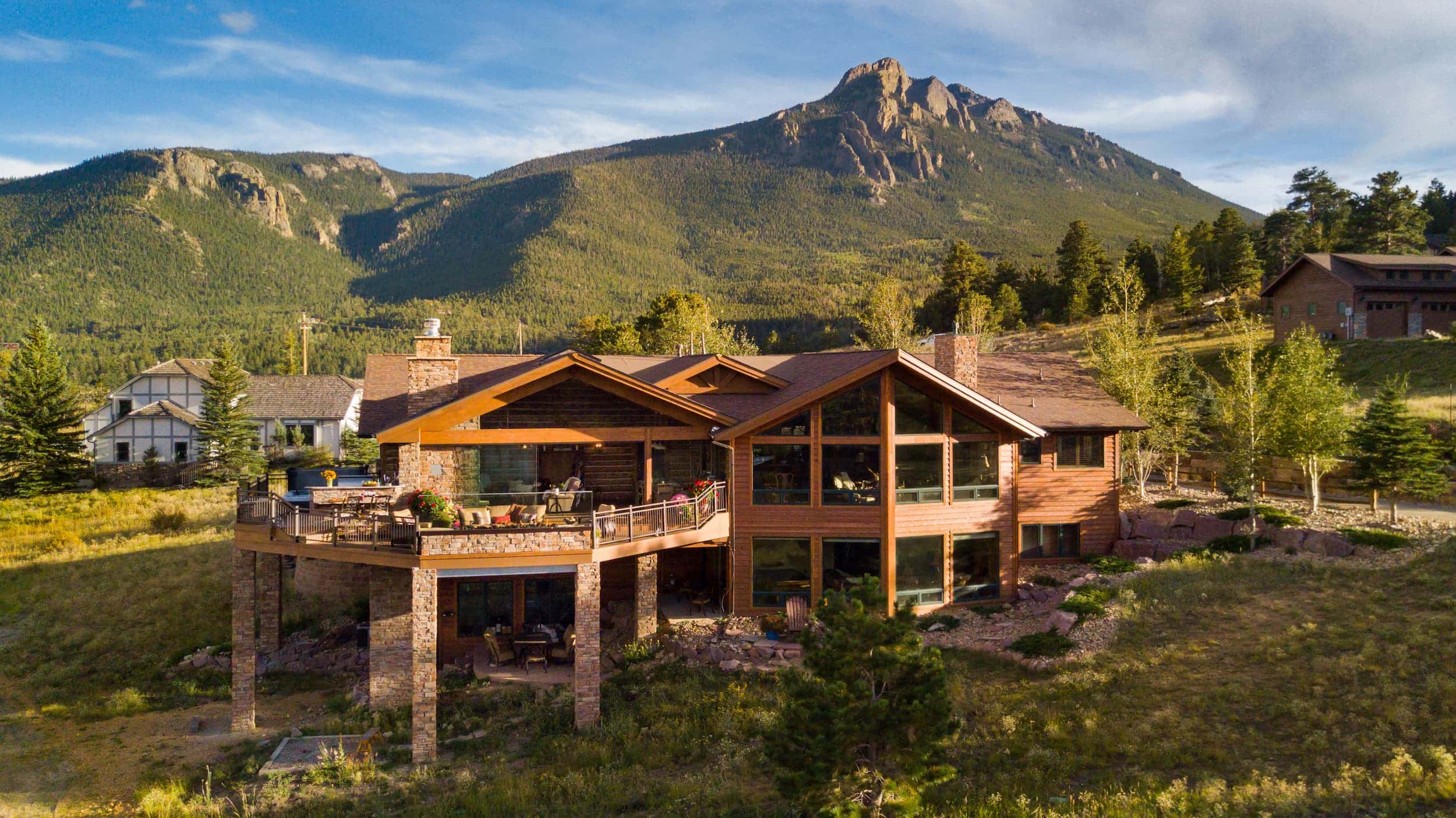 An aerial view of a home with mountains in the background.