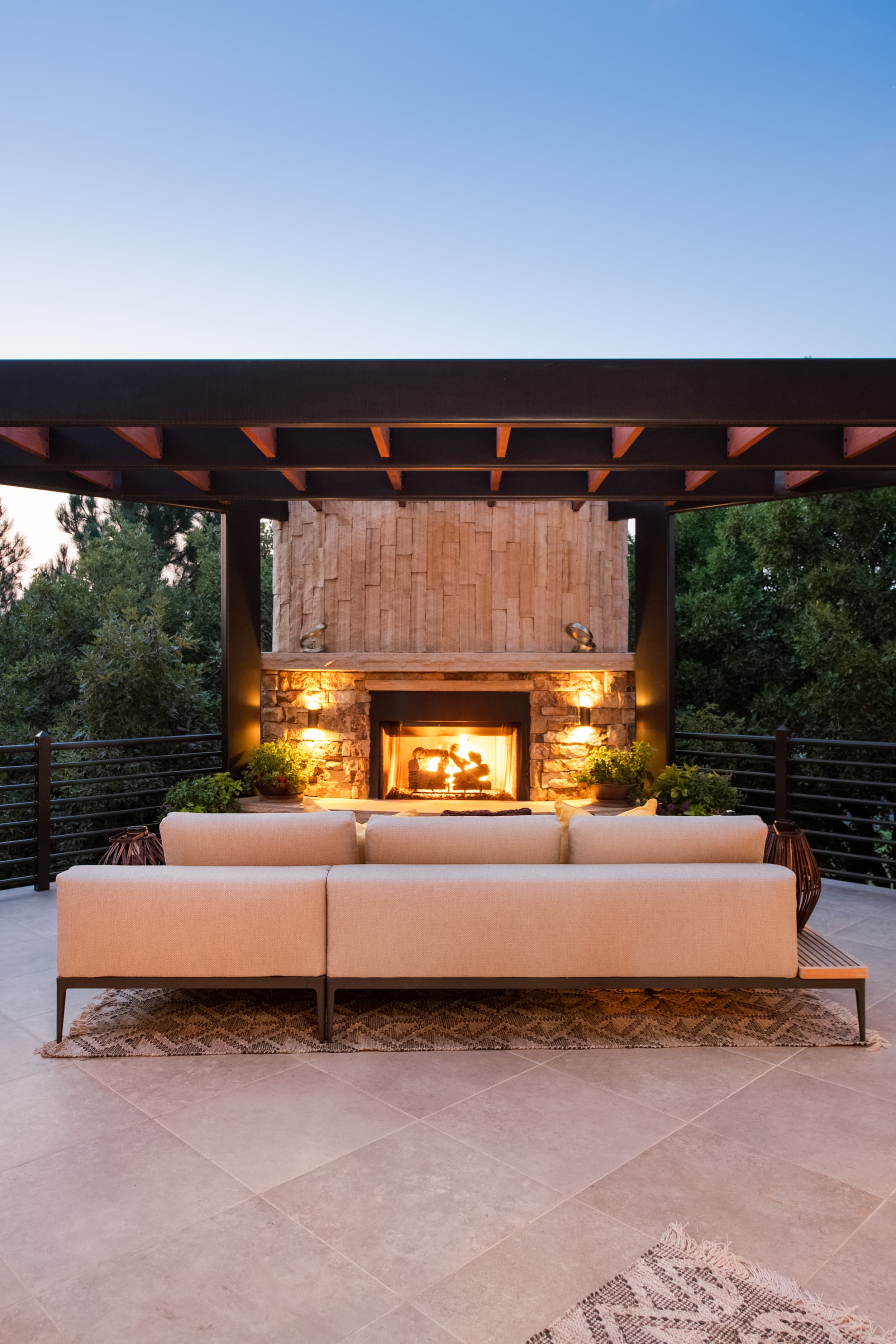 A couch and a fireplace on a deck.