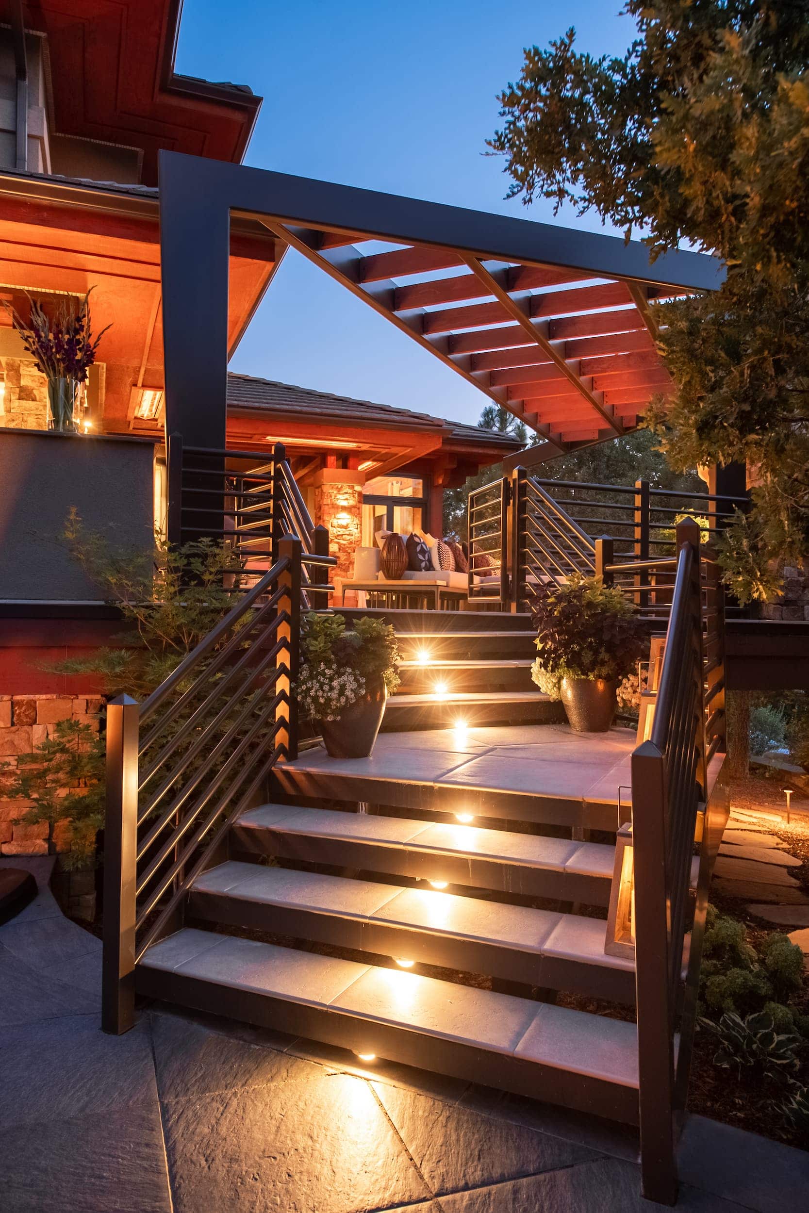 A modern outdoor staircase with lighting at dusk.