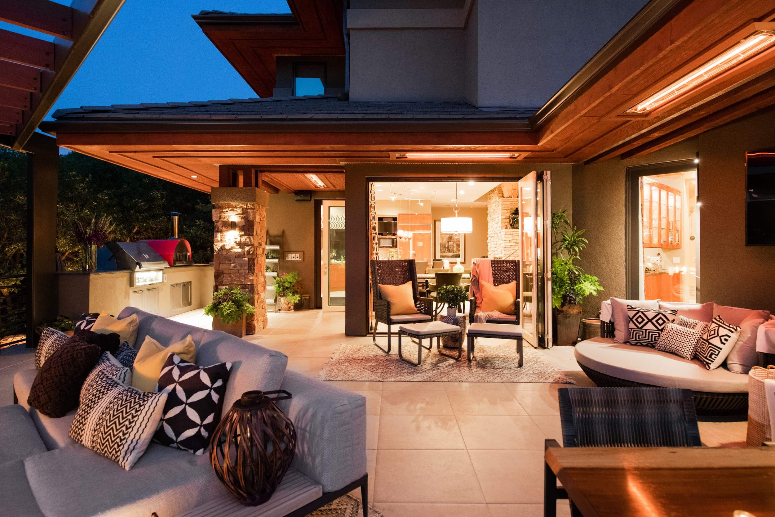 An outdoor living area with furniture and lighting.