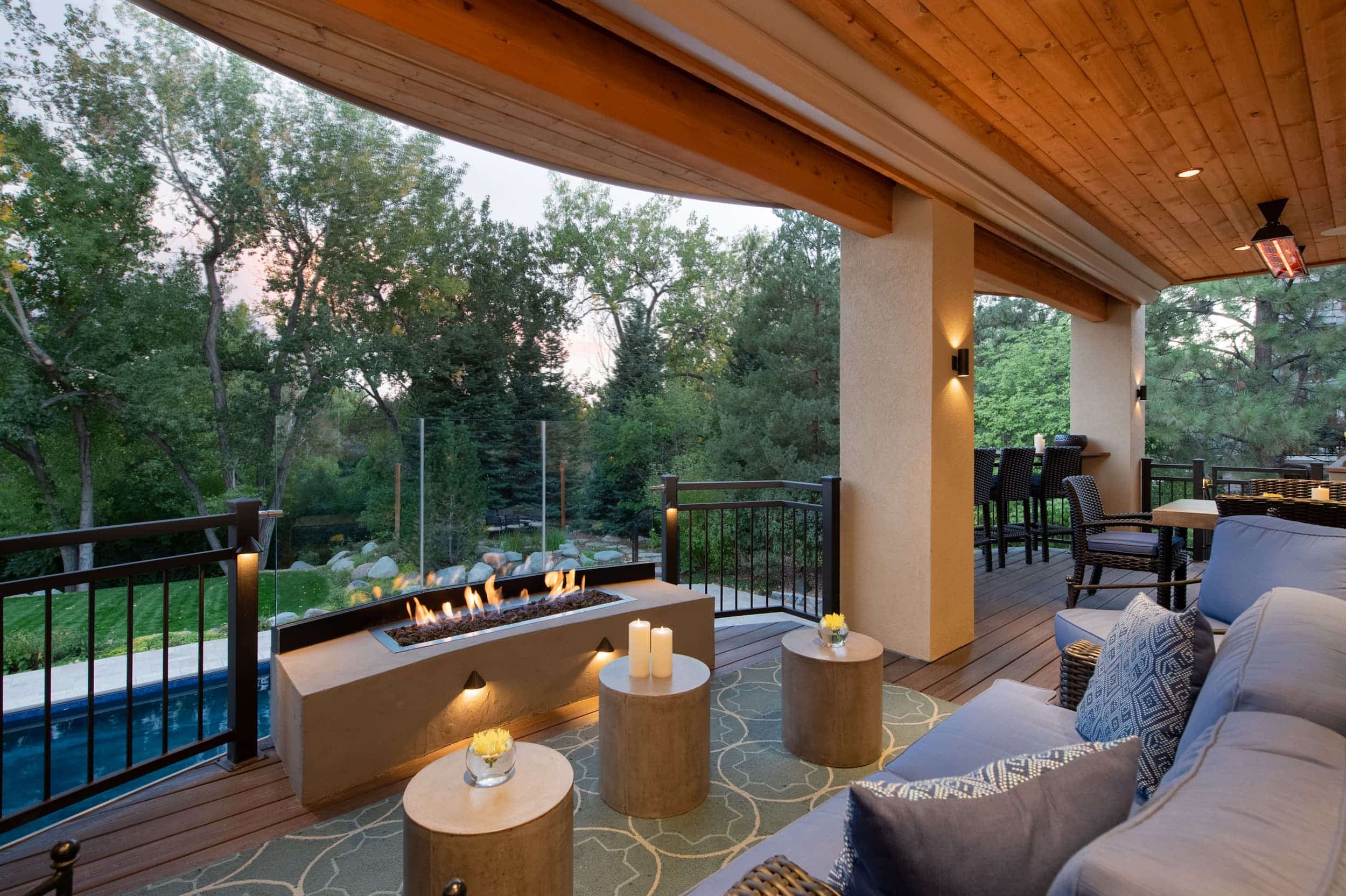 An outdoor living area with a fire pit and couches.
