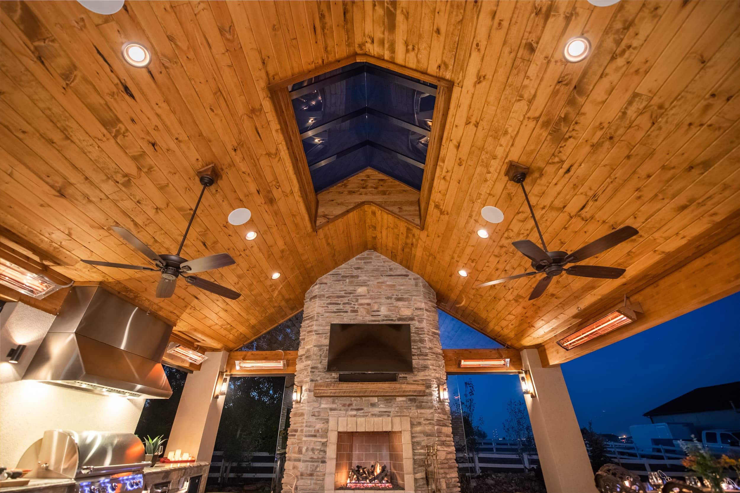 A room with a fireplace and ceiling fans.